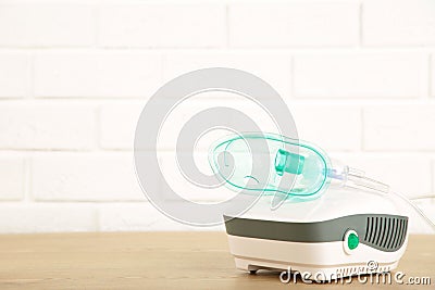 Compressor nebulizer with mask on table. Top view Stock Photo