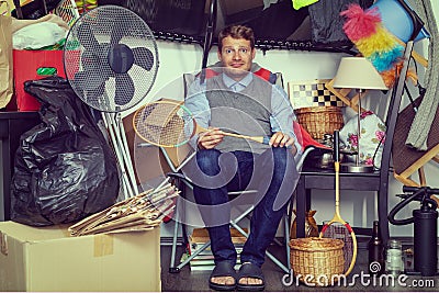compulsive hoarding disorder concept - man hoarder with stuff piles Stock Photo