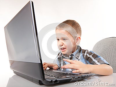 Computer addiction emotional boy with laptop Stock Photo