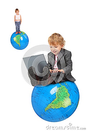 Computer boy on big globe and girl on globe Stock Photo