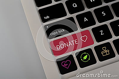 A computer button with the text DONATE. The concept of spread awareness and encourage donations for health, those in need, and Stock Photo