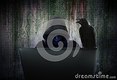 Computer hacker in black mask and hood are hacking data Stock Photo