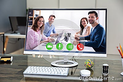 Computer Desktop With Videoconferencing Application On Desk Stock Photo
