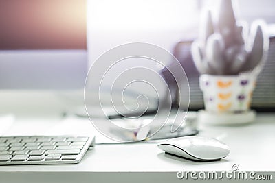 Computer desktop with white keyboard and mouse on working desk Stock Photo