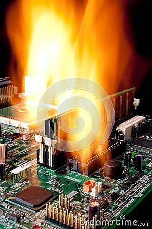 A computer electronic mother board on fire Stock Photo
