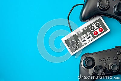 Computer games and gaming console concept theme with video game controllers isolated on blue background with copy space Stock Photo