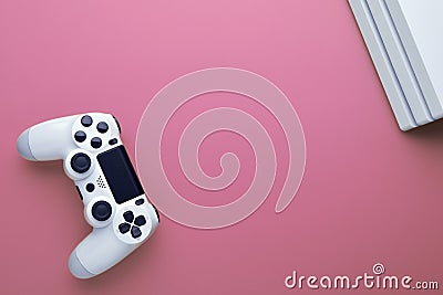 Gaming concept. Computer gaming. White joystick and conor of gamepad console on pink background Stock Photo