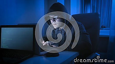 Computer hacker criminal coding virus on latop at night Stock Photo