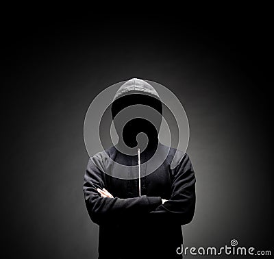 Computer hacker in hoodie. Obscured dark face. Data thief, internet fraud, darknet and cyber security concept. Stock Photo