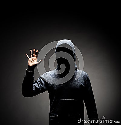 Computer hacker in hoodie. Obscured dark face. Data thief, internet fraud, darknet and cyber security concept. Stock Photo