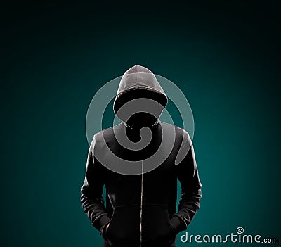 Computer hacker in hoodie. Obscured dark face. Data thief, internet fraud, darknet and cyber security concept. Stock Photo