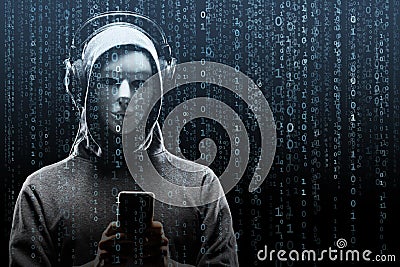 Computer hacker in mask and hoodie over abstract binary background. Obscured dark face. Data thief, internet fraud Stock Photo