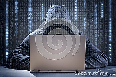 Computer hacker stealing data from a laptop Stock Photo