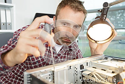Computer hardware engineer fixing cpu Stock Photo