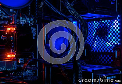 Computer illuminated by internal LED RGB lights, hardware inside open high performance desktop PC Stock Photo