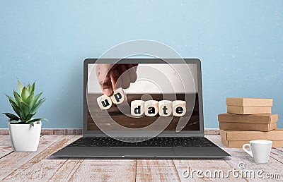 Computer with image of a hand stacking cubes with the message UPDATE Stock Photo