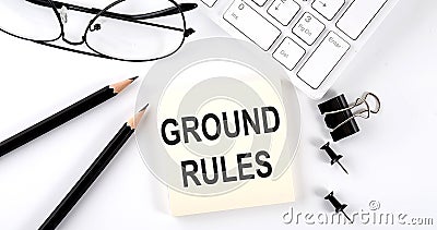 The computer keyboard with sticker text GROUND RULES with pencils Stock Photo