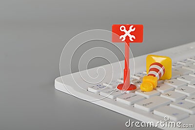 Computer keyboard, traffic cone and wrench symbol. Website maintenance, programming, repair, coding and under maintenance concept Stock Photo
