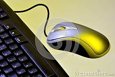Computer keyboard and wired mouse to enter information. Office Desk with the necessary accessories - computer keyboard for typing Stock Photo