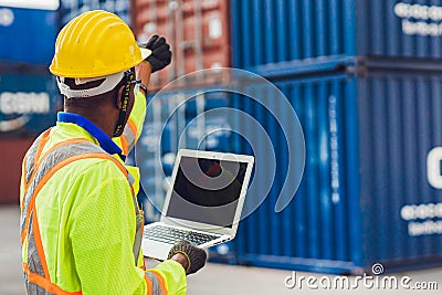 Computer laptop blank screen with back view of foreman staff worker working in logistic control loading containers at port cargo Stock Photo