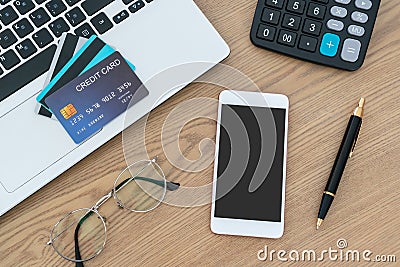Computer laptop, credit cards, calculater, notbook pen and glasses on the desk, account and saving concept Stock Photo