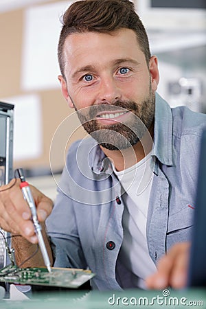 Computer master wipes screw with screwdriver Stock Photo