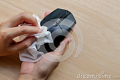 Computer mouse wiping by alcohol clean pad for disinfect virus bacteria, prevent from epidemic of disease during the corona virus Stock Photo