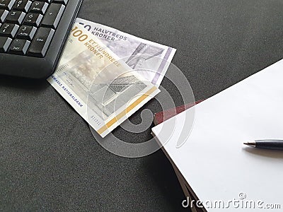 computer numeric keypad, danish money, books and pen Stock Photo