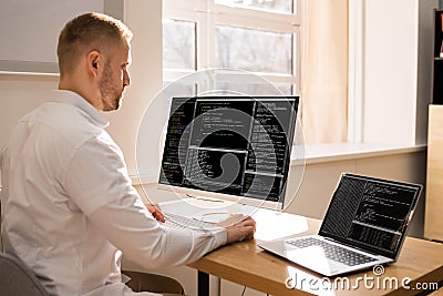 Computer Programmer Writing Program Code On Computer Stock Photo