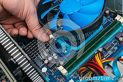 Computer repair, replacement of the processor cooling system. Maintenance of computer equipment Stock Photo