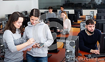 Computer science teacher checks student results Stock Photo