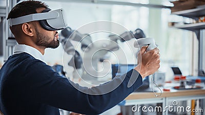 Computer Science Worker in Virtual Reality Headset Holding Controllers and Moving Bionic Claw. Man Stock Photo