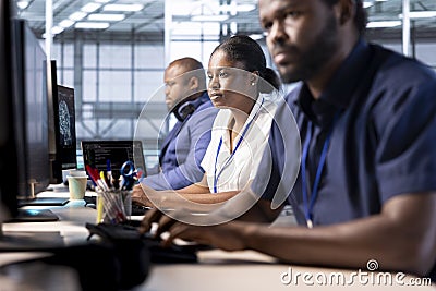 Computer scientists working in server hub, maintaining databases Stock Photo