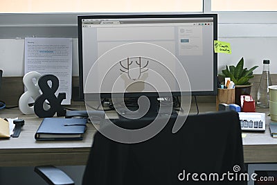 Computer Screen Showing Graphic Deer Design on Office Table Work Stock Photo