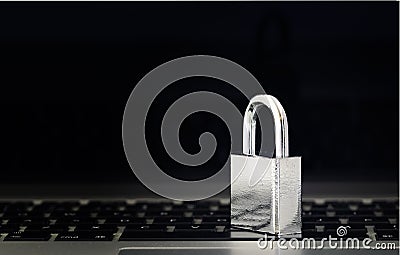 Computer Security Concept with a Closed Padlock on the Keyboard on Black Background Stock Photo