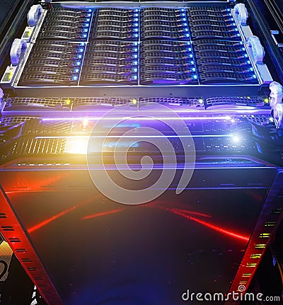 Computer Server mount on rack in data center room with red lighting alarm. bottom view on the cluster storage of Stock Photo