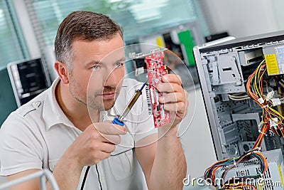 Computer specialist repairing printed circuit Stock Photo