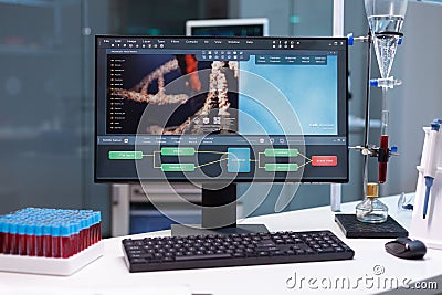 Computer standing on table with microbiology research on display during pharmaceutic biochemical experiment Stock Photo