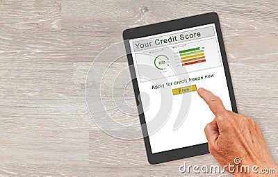 Computer tablet with with credit report and freeze button Stock Photo