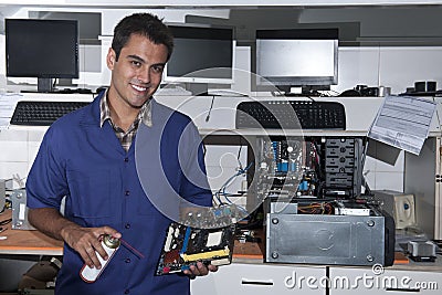 Computer technician with motherboard at workshop Stock Photo