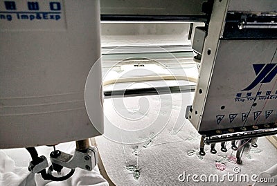 Computerized embroidery knitting machines deals a design in fabric Editorial Stock Photo