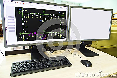 Computers and monitors with schematic diagram for supervisory, control and data acquisition Stock Photo