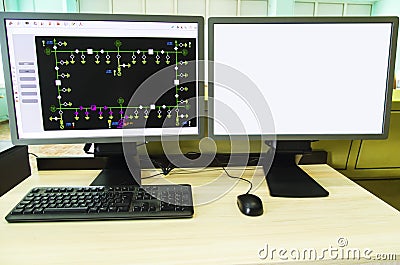 Computers and monitors with schematic diagram for supervisory, control and data acquisition Stock Photo