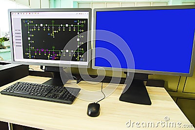 Computers and monitors with schematic diagram for supervisory, control and data acquisition Stock Photo