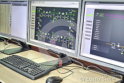 Computers and monitors with schematic diagram for supervisory, control and data acquisition Stock Photo