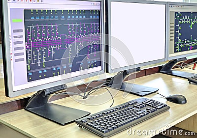 Computers and monitors with schematic diagram for supervisory, control and data acquisition Stock Photo