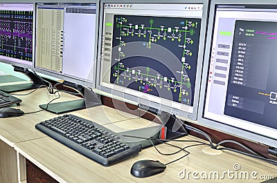 Computers and monitors with schematic diagram for supervisory, control and data acquisition Stock Photo