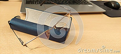 Computers. Office desk with laptop and glasses in case Stock Photo