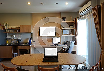 Computers and TV blank screen in modern room, mock up Stock Photo