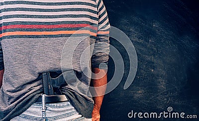 Conceal carry concept, african american male with handgun tucked into back of pants Stock Photo